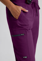 Greys Anatomy Kim 3 Pocket Elastic Back Waistband Zip-Pocket Pants | Wine